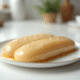 Foie gras en portion prêt à congeler sur plan de cuisine blanc